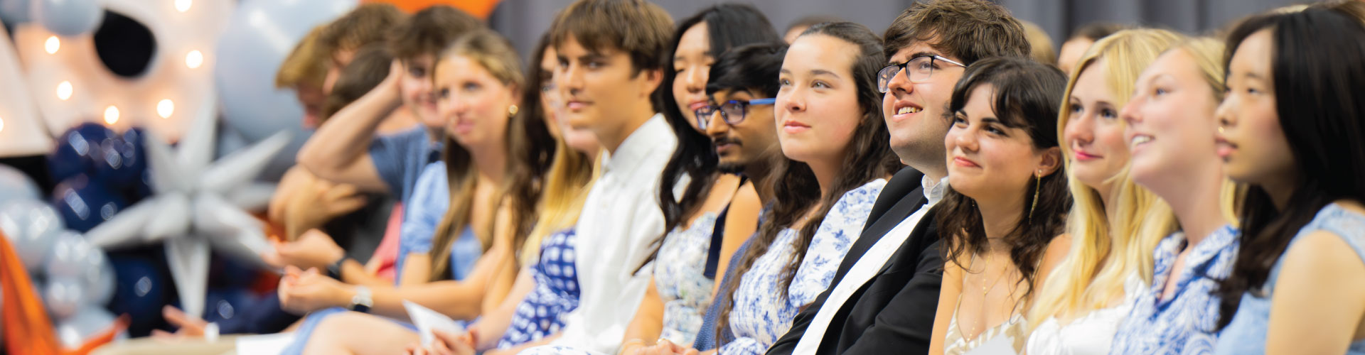 image of students sitting in a formal event