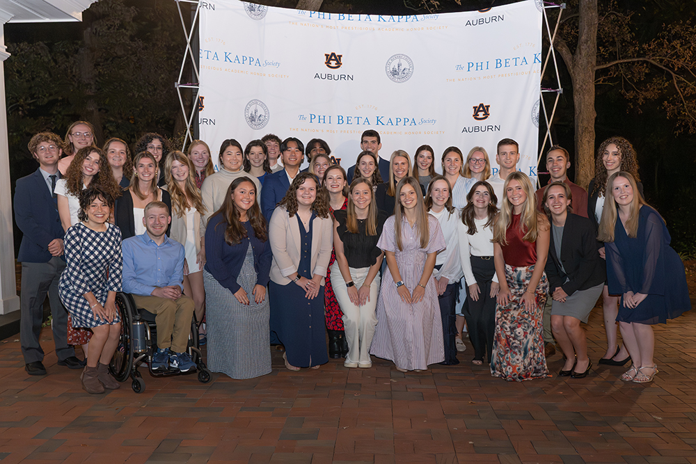 large group of students in front of a phi beta kappa pop up screen